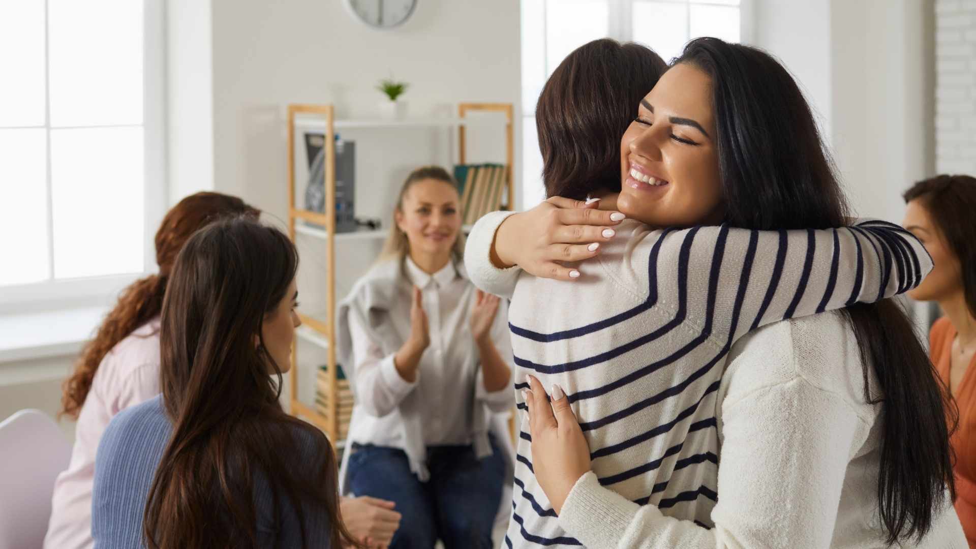 Client receiving supportive care inside a calm, residential-style wellness center.
