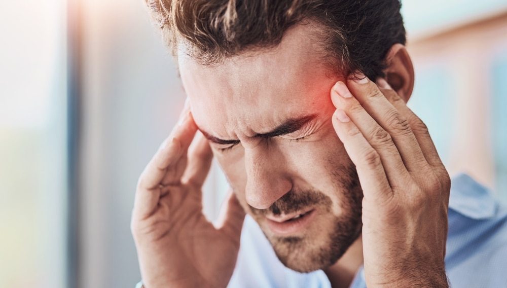 Our Blog 19 Man struggling with addiction clutching his temples